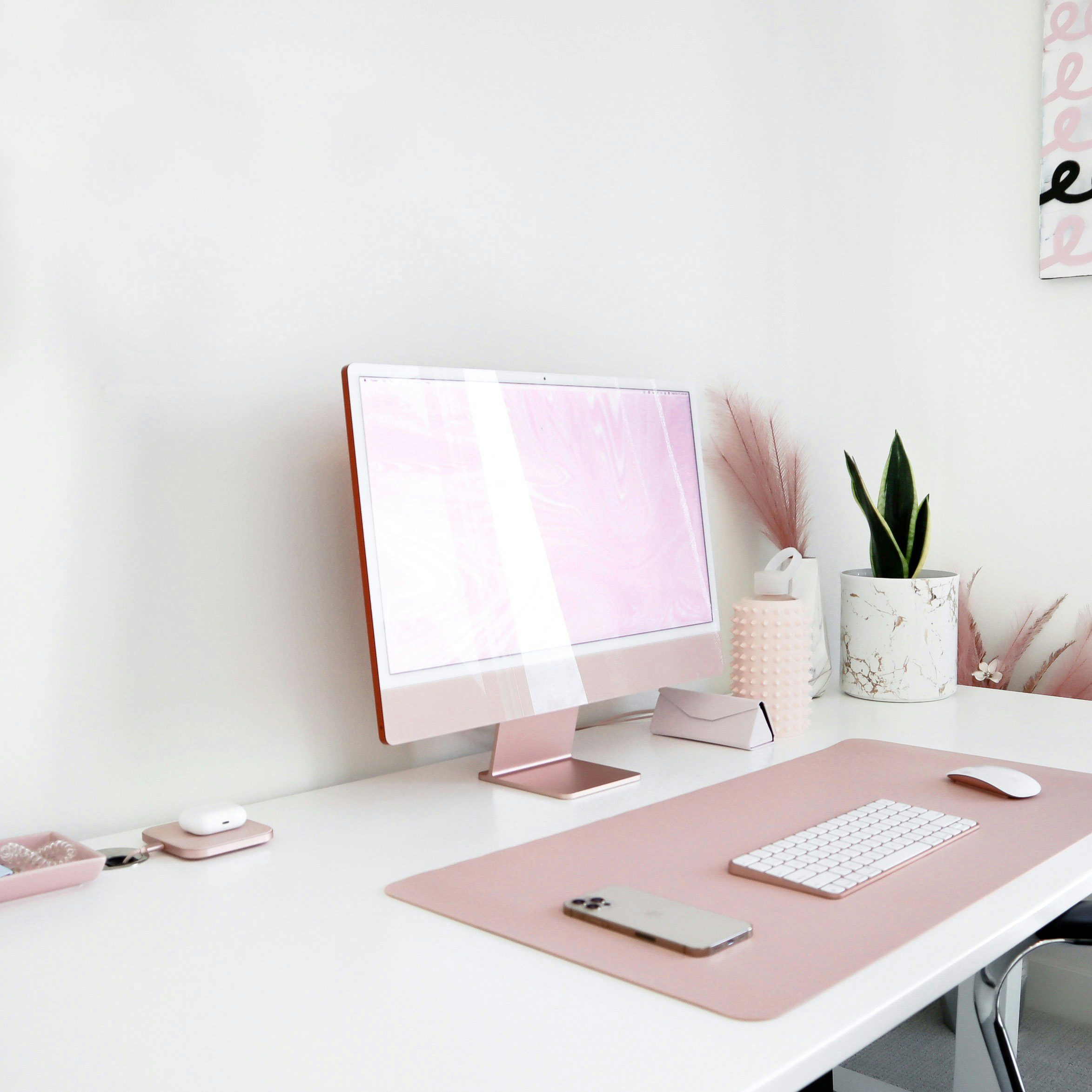 Web designer workspace with pink computer